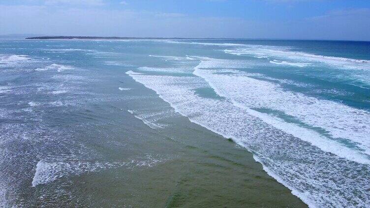 一排排浪花冲刷着沙滩