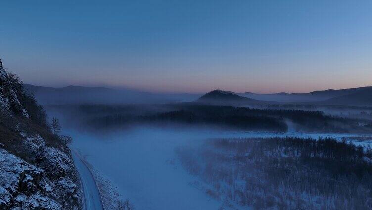 航拍林海雪原雪林冻雾和山路