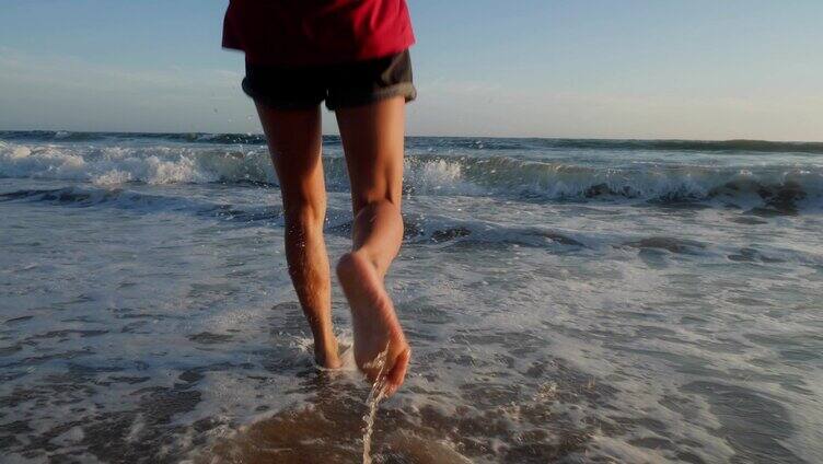赤脚跑向海浪的美丽女子背影特写慢镜头