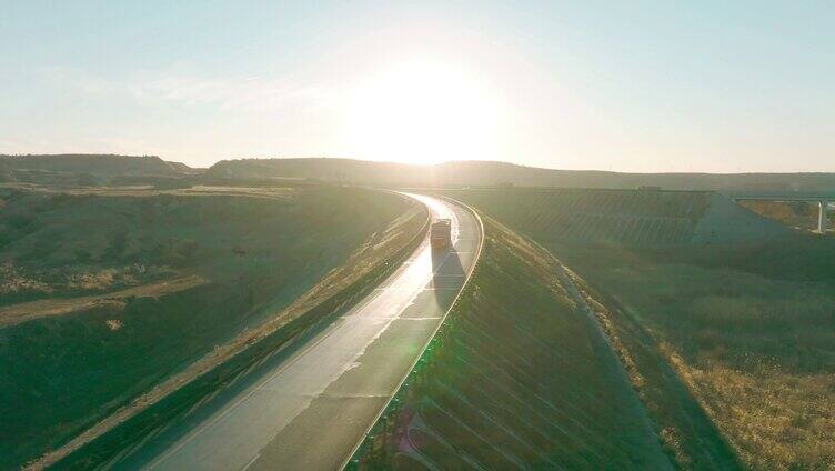 航拍夕阳下高速公路卡车货车行驶