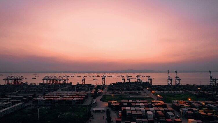 4K航拍货运港口码头红色朝霞映照天空视频