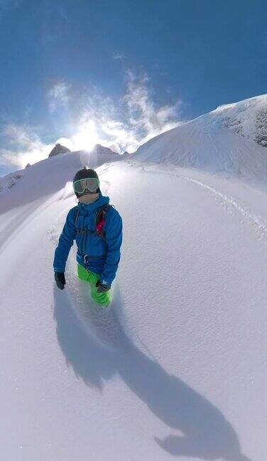 垂直:快乐的人在风景优美的山上玩滑雪板。