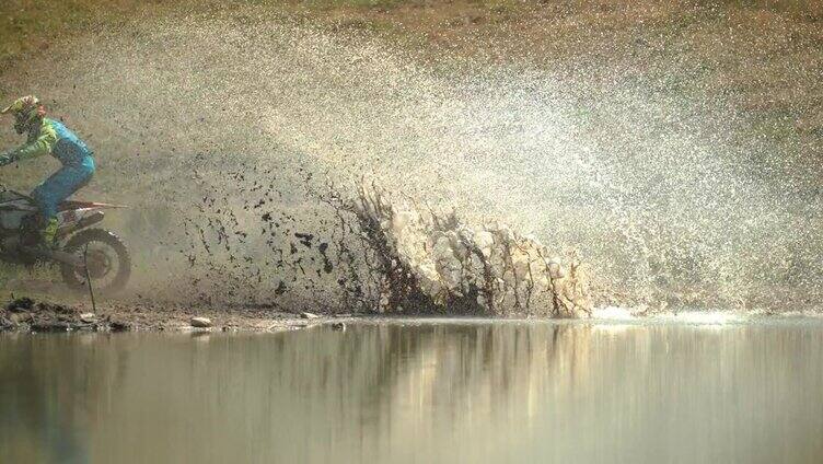 在池塘边骑行溅起泥水