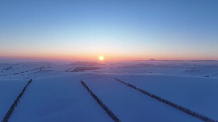 航拍浓郁夕阳下的垦区雪原