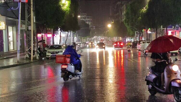  清明时节城市春雨街头夜晚车灯雨点滴下雨