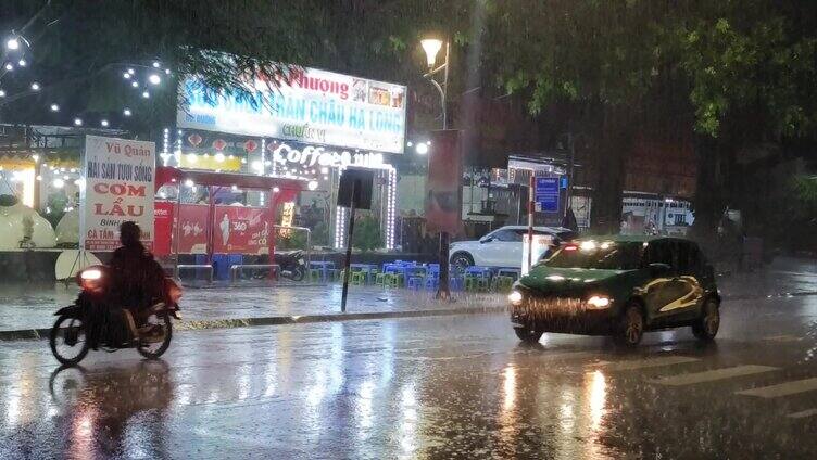 清明时节城市春雨街头夜晚车灯雨点滴下雨