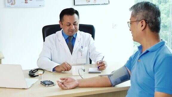 病人访视医生-营养学家与老年病人会诊检查血压