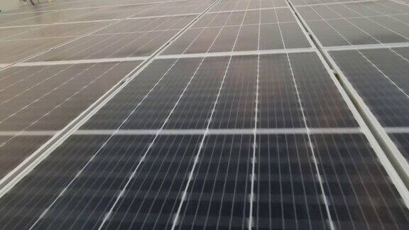 无人机视图移动真正接近大型太阳能电池板阵列4K鸟瞰图太阳能电池板农场(太阳能电池)与阳光