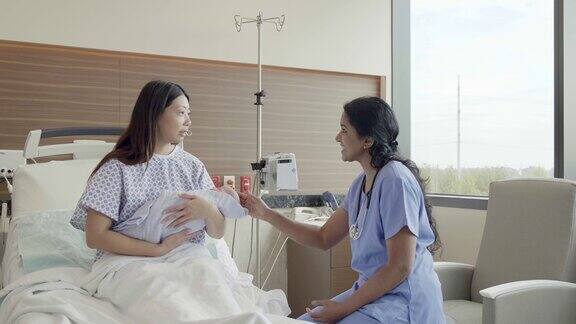 有爱心的儿科医生与新妈妈讨论新生儿护理