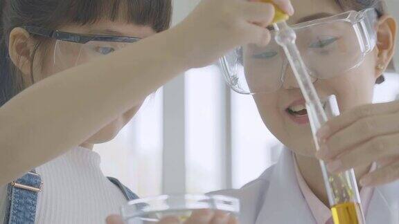 亚洲小女生在科学实验课上学习科学和教育