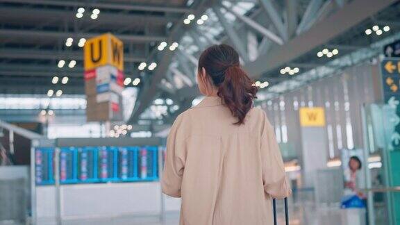 女子在机场航站楼与行李箱行李行走旅游旅行
