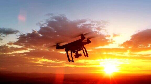 四轴飞行器飞向美丽的日落景色现代电子产品
