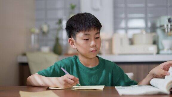 亚洲小男孩在家里做作业