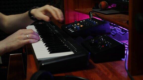 音响工程师在数字音频工作站混音和mastering作曲家演奏钢琴midi键盘在家庭音乐工作室与监视器混音装置