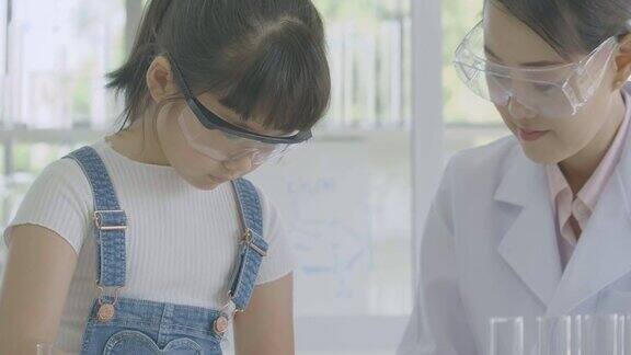 亚洲小女生在科学实验课上学习科学和教育
