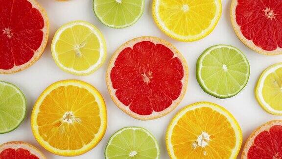 切片新鲜柑橘类水果柚子橙子柠檬酸橙猕猴桃旋转旋转孤立的白色背景接近您的顶视图设计健康的水果夏季新鲜水果小吃概念维生素C