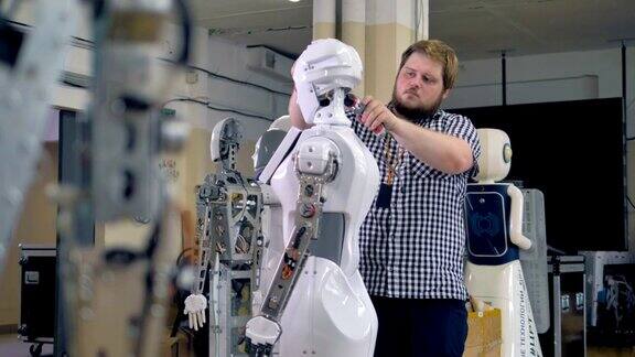 一个年轻的工程师拆开一个机器人的头