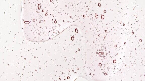粉红色透明化妆品凝胶流体与分子气泡流动微距镜头