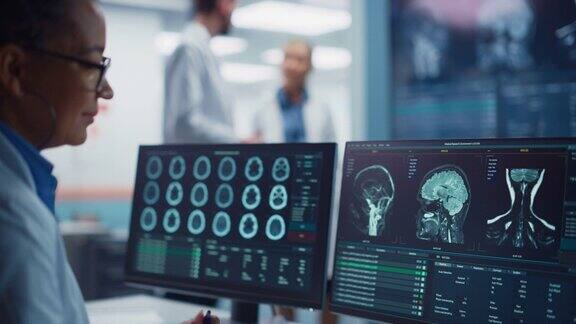 医学医院卫生保健实验室:摄像机从专业神经科学家分析CT扫描为病人寻找治疗到女性神经学家使用计算机与大脑扫描MRI图像