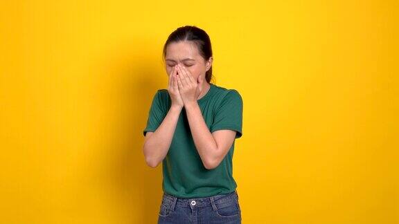 亚洲妇女生病喉咙痛站在孤立的黄色背景