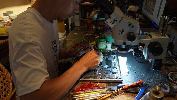 一个中年男子修理电子设备的镜头