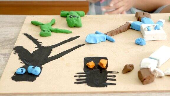 孩子的手在桌上玩着五颜六色的泥和颜料手指精细运动技能的发展和创造力教育
