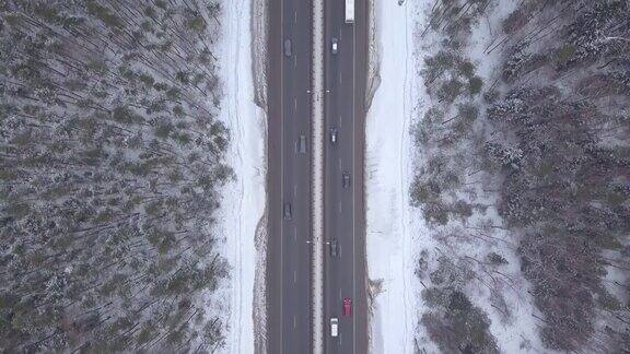 冬季积雪公路交通鸟瞰图在暴风雪路上行驶的汽车