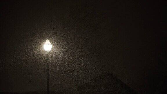 雪花飘落的夜晚只有一盏路灯在风暴中闪烁