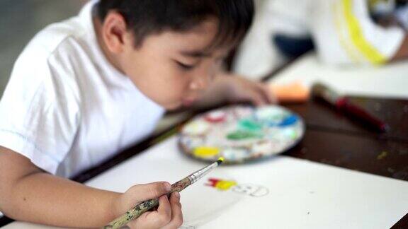 年轻的亚洲孩子在艺术教室绘画和自信在学校