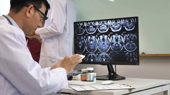 医生在医院办公室用平板电脑检查核磁共振扫描