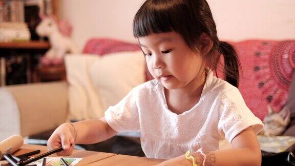 一个亚洲女孩在家画画