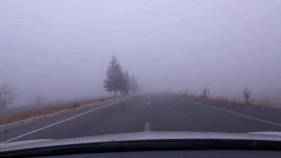 一辆汽车在雾蒙蒙的路上行驶