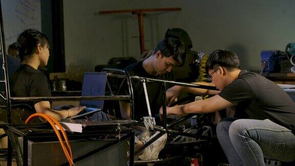 摄影小组的年轻亚洲机械工程师在工作室车间工作技术与创新理念