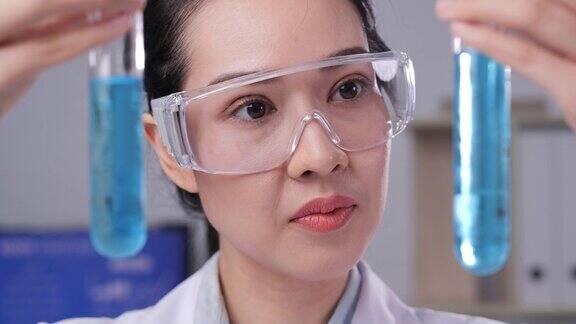 女科学家在实验室里检查试管中的液体