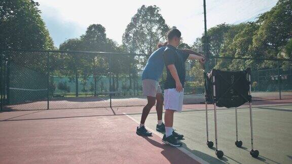 亚洲华人唐氏综合症男子在周末早上向教练学习打网球