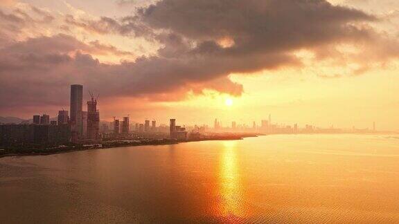 航拍深圳城市和日出时的大海