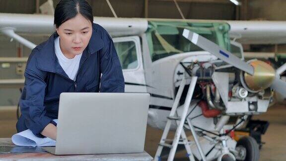 领导亚洲少女在飞机机库使用开发工程师电脑女性在STEM技术科学创新领导力赋权专业知识导师技术员人成功教育话题工业4.0