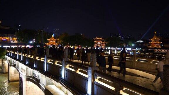 夜间灯光照亮南京古城江边游船码头拥挤的大桥全景4k中国