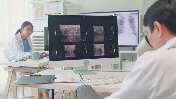 成年亚洲男医生在医院电脑屏幕上检查病人的x光图像医疗保健