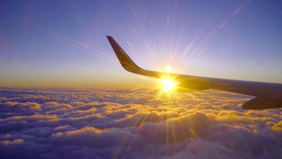美丽的金色日落日出飞行与太阳光束和飞机机翼
