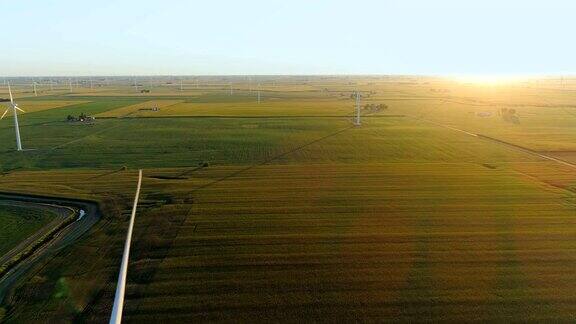 飞过乡间田野和风力发电厂直到日落