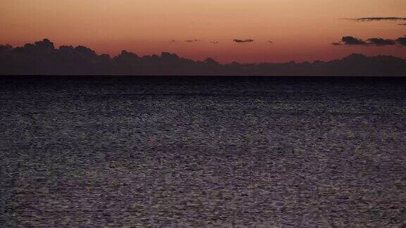 太阳落山后海面上的红橙色天空时间流逝