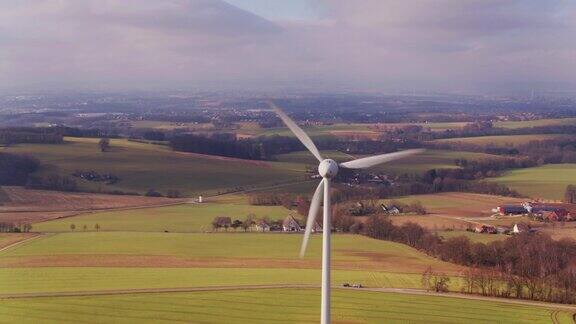 在德国田园风景中环绕风力涡轮机飞行