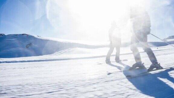 在一个完美的阳光灿烂的冬日滑雪者在田园诗般的滑雪胜地滑雪道上滑行