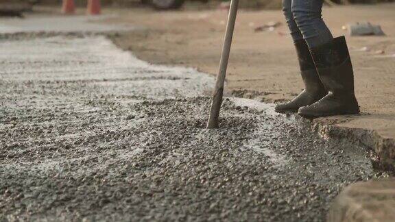 手工工人用泥铲把水泥路面擦平