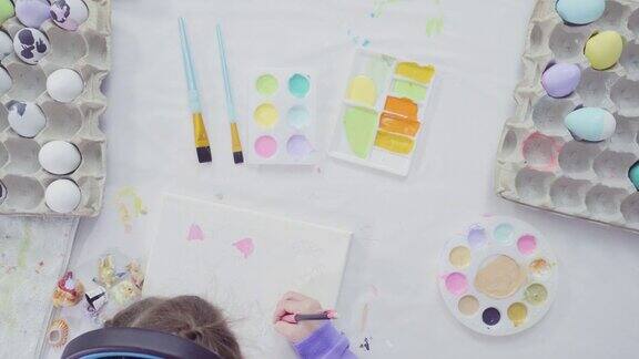 小女孩和她的妈妈用丙烯酸颜料画复活节艺术项目