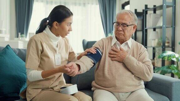 专业个人护理人员照顾老年男性使用血压计检查血压