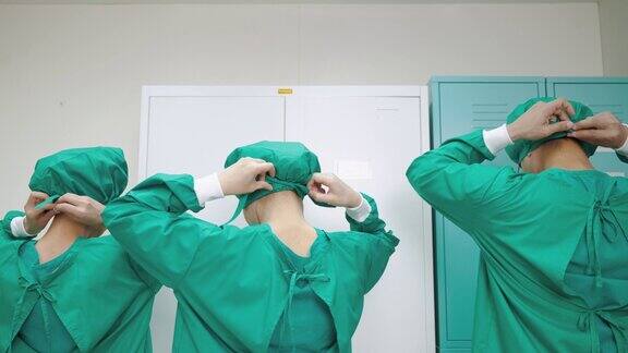 手术小组穿着手术服准备进入无菌手术室进行安全手术医学观念与保健治疗