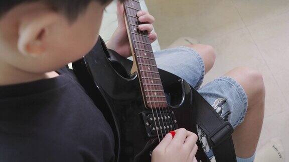 亚洲男孩玩电吉他