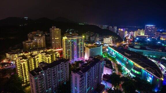 夜晚照亮三亚著名的大东海海滩小镇屋顶全景4k时间推移海南岛中国